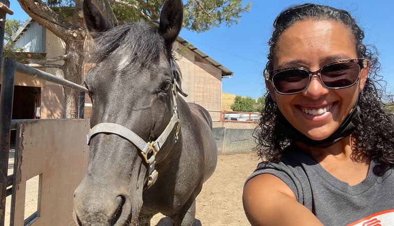 Jess with a horse she works with.