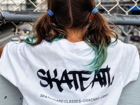 a girl wearing skateatl t-shirt