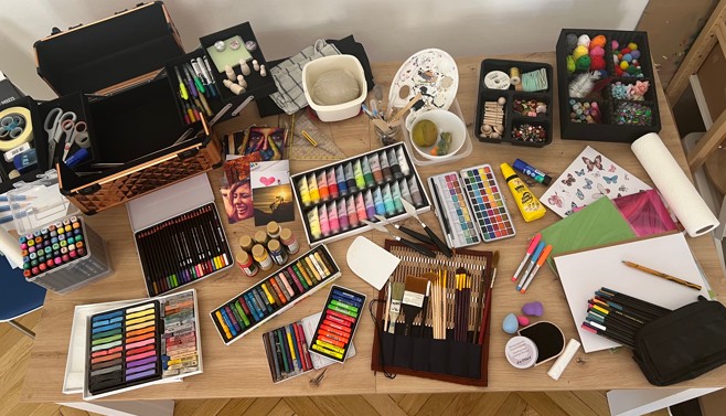 a table with a variety of art supplies and supplies