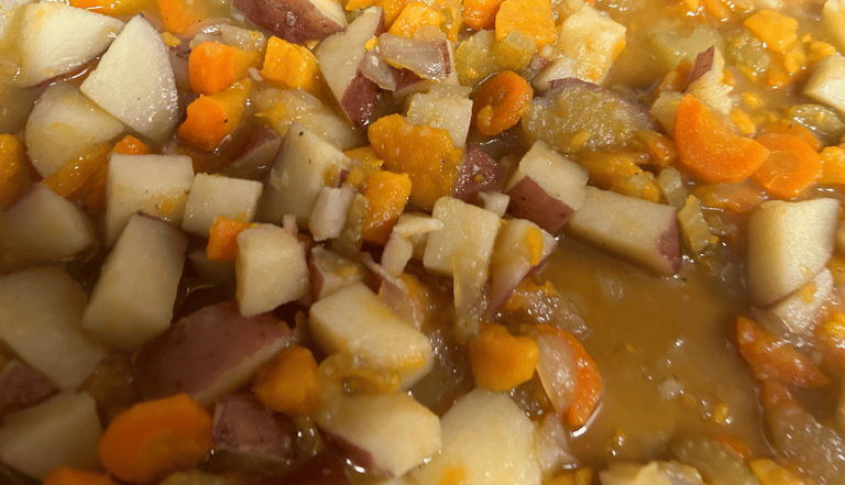 Vegetable soup with a blend of potatoes, sweet potatoes, carrots, celery and broth shown.