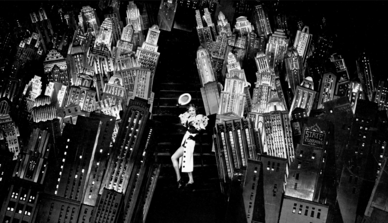 Ruby Keeler with glowing New York skyline cutouts – 42nd Street finale magic