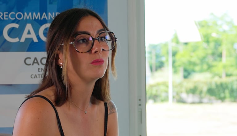 a woman in glasses and a black top