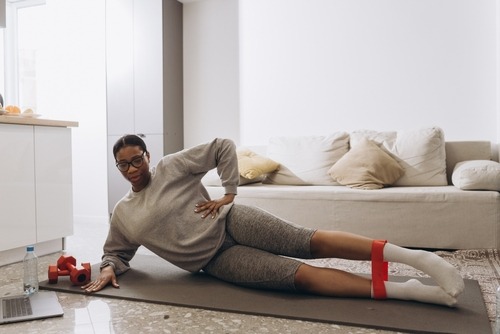 a woman in a gray sweater and red socks