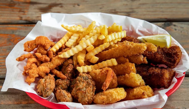 Captain’s Combo Platter Meal with fried fish, clams, oysters, shrimp, calamari, and crinkle‑cut fries from Captain’s Galley