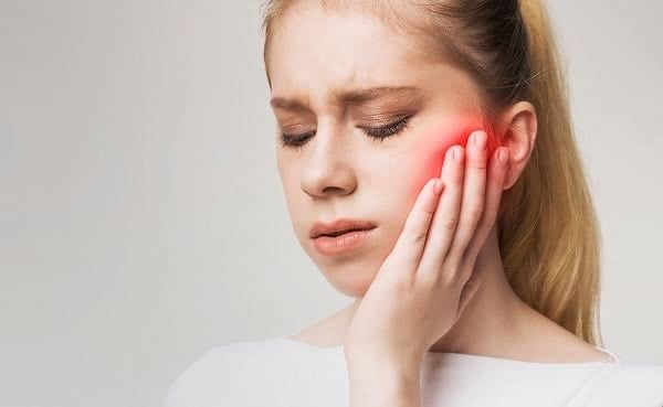 TMJ pain causing difficulty in chewing and jaw stiffness. 