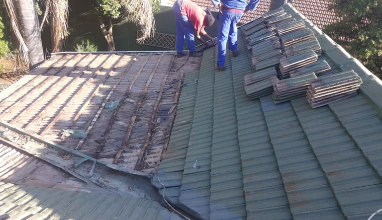 Roof tiles removed to expose damaged battens and waterlogged timber