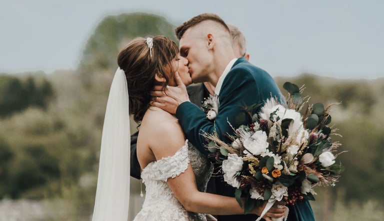 bride and groom share first kiss after ceremony, Kalispell mountains