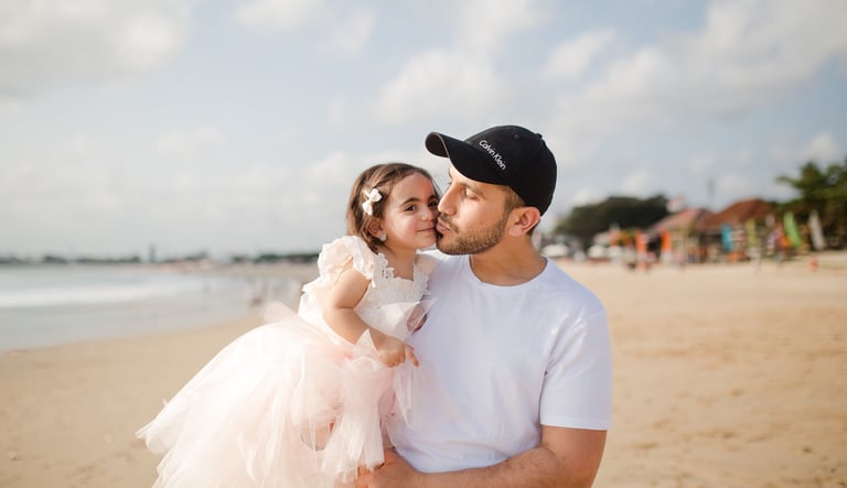 family photography Jimbaran Beach Bali father and daughter walking along shoreline