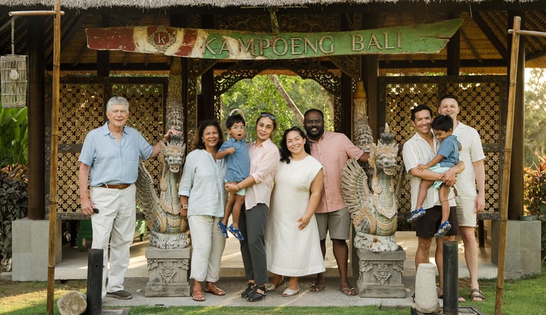  family standing in front of traditional balinese pavilion at rimba by ayana bali during a luxury family photography session