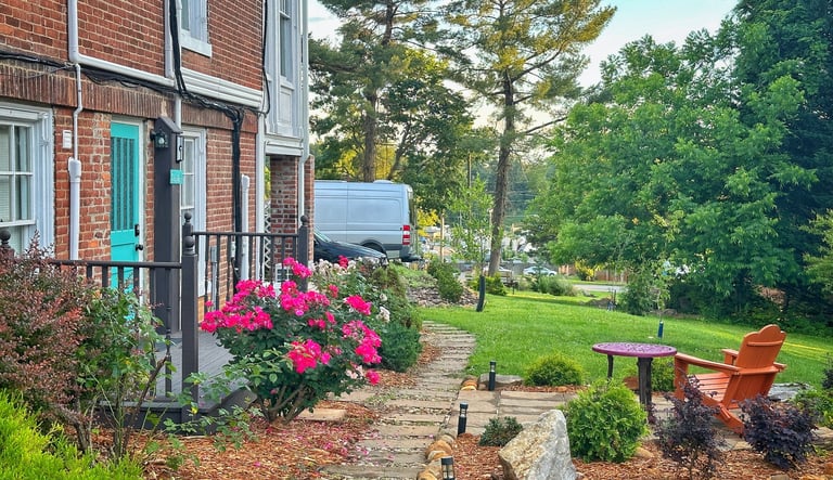 a garden with a bench and a table
