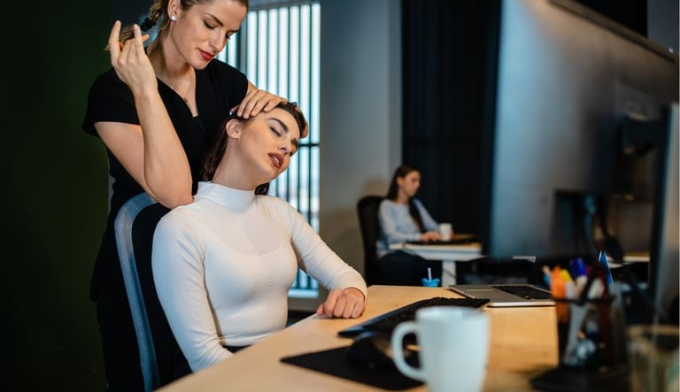 a busy professional getting a massage at her desk by a Remedly physio