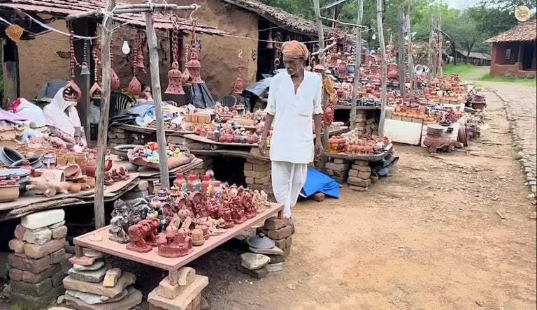 Local artisans displaying handmade terracotta handicrafts at Shilpgram, Udaipur.