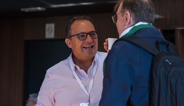 a man in a pink shirt and a man in a blue jacket