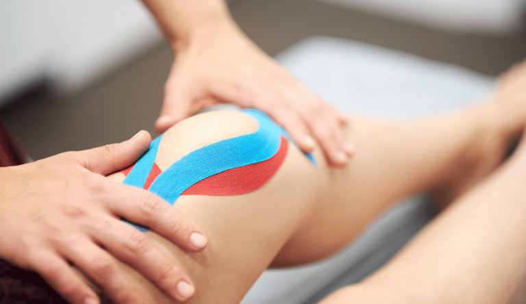 Blue and red taping done on the knee for patella