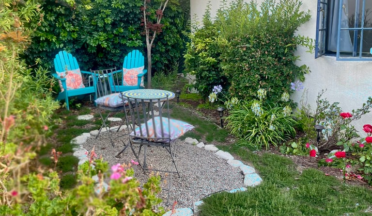 a patio with a table and chairs in the yard