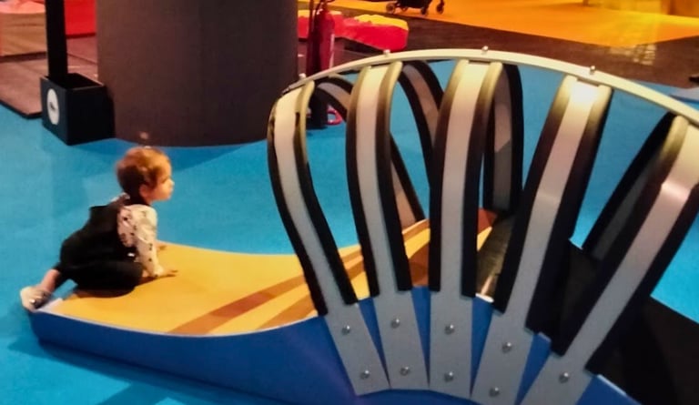 a child's play area with a large chair and a large chair