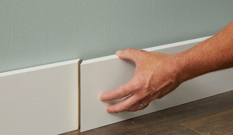 Baseboard trim covering the edge gap between wall and flooring.