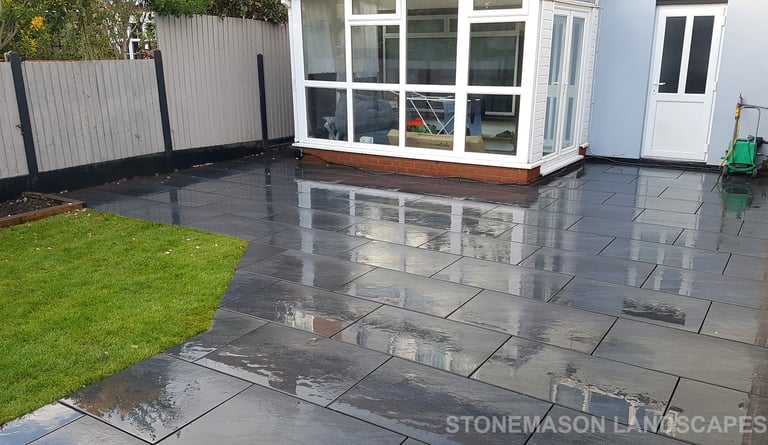 Grey sandstone circle paving slabs with charcoal edging