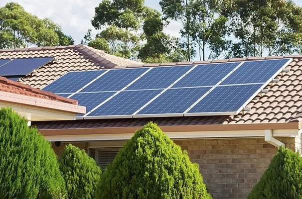 Residential solar panels installed on a tiled rooftop for renewable energy and lower utility bills.