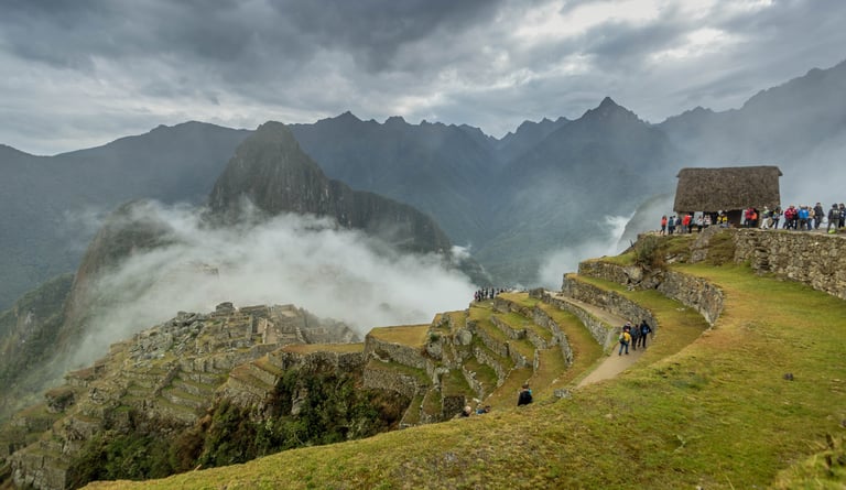 Photographer capturing Quechua weaver at traditional loom in Lares Valley, Peru