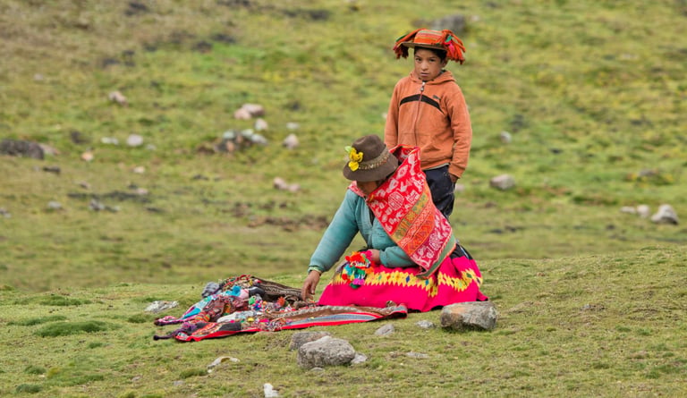 Photographer capturing Quechua weaver at traditional loom in Lares Valley, Peru
