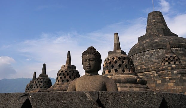 a buddha statue in front of a large buddha statue
