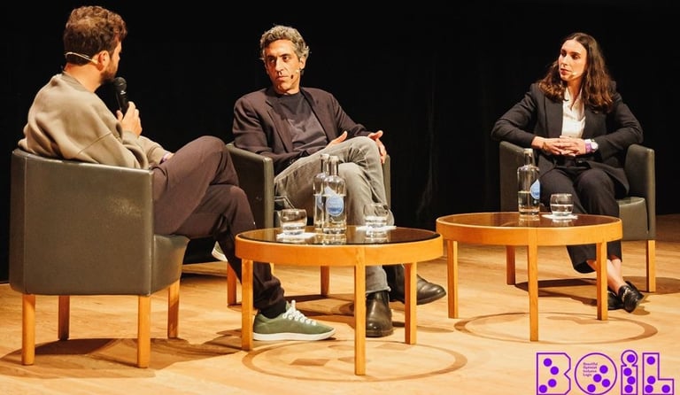 a man and woman sitting in chairs in a room