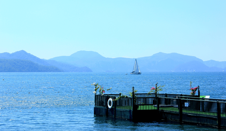 a sailboat is docked at a pier in Lake Köyceğiz, one of the best places to visit in Dalyan