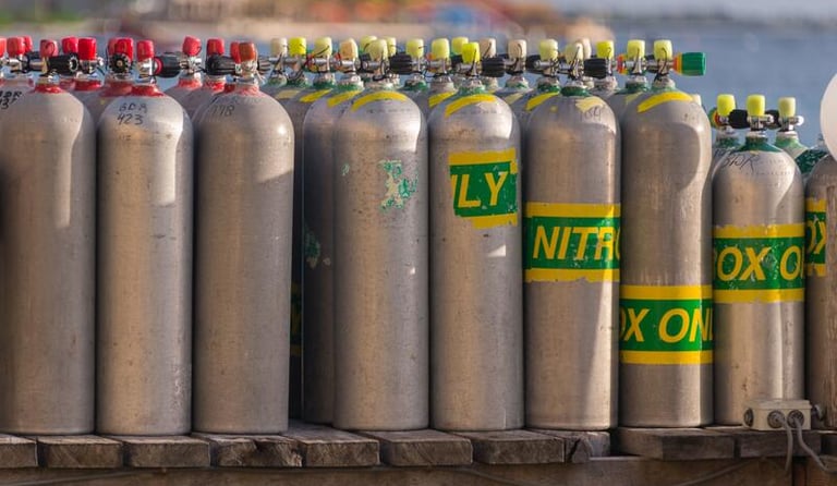 a bunch of gas bottles of gas on a trailer