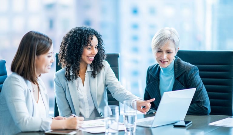 a group of business people sitting around a table