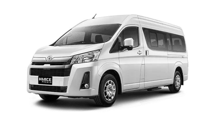 Toyota Hiace Premio warna putih dengan pintu geser velg warna silver pandangan dari kiri depan.
