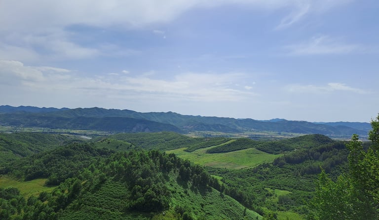 a view of a mountain range with a bench and a bench