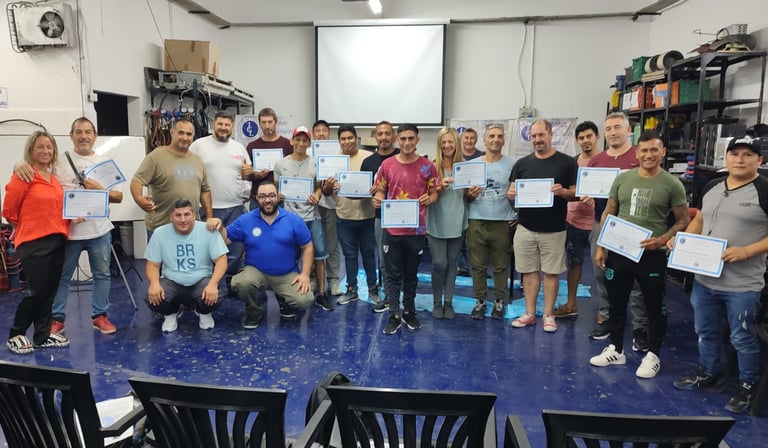 a group of people standing around a table with certificates. , Entrega de Certificados en ICL