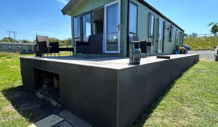 Smooth render coat on a bungalow exterior for a modern look.