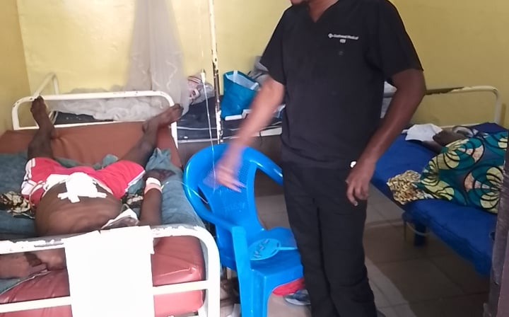 a man in a hospital room with a nurse and a nurse