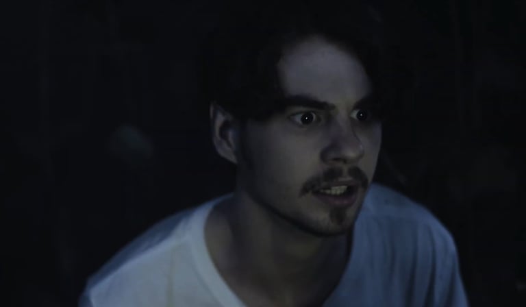 a man with a mustache and a white shirt