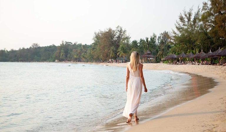 Woman walking along the beach during a sunset photoshoot in Phu Quoc