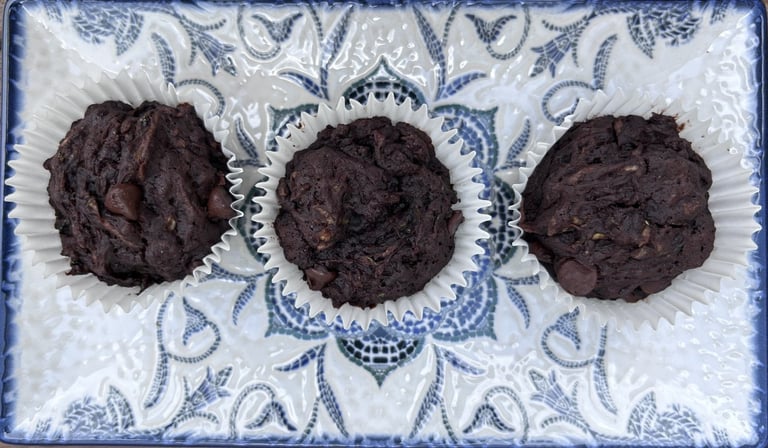 Three dairy and egg free chocolate and marrow muffins on a tray