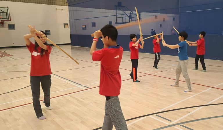 boys and girls practicing kenjutsu together