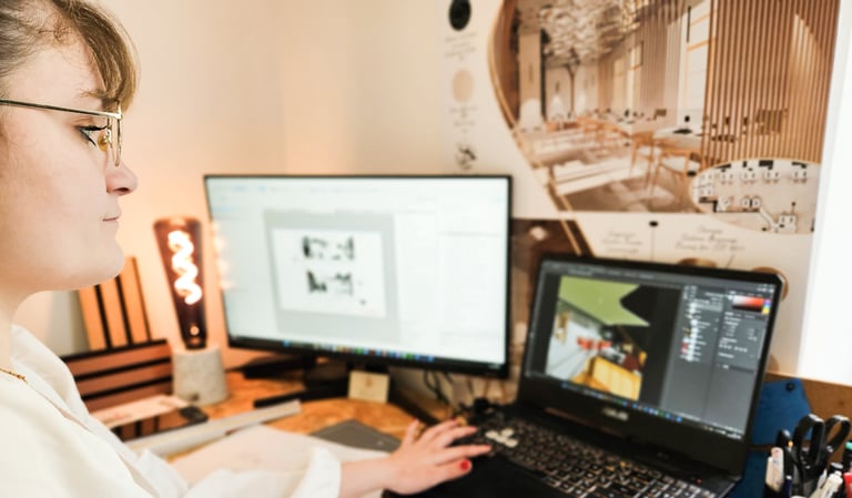 a woman sitting at a desk with a laptop and a notebook