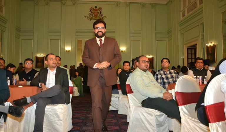 Speaker addressing an engaged audience at a formal event.