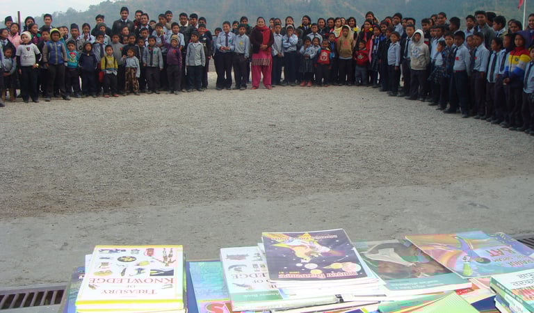 a group of students standing around a table with books