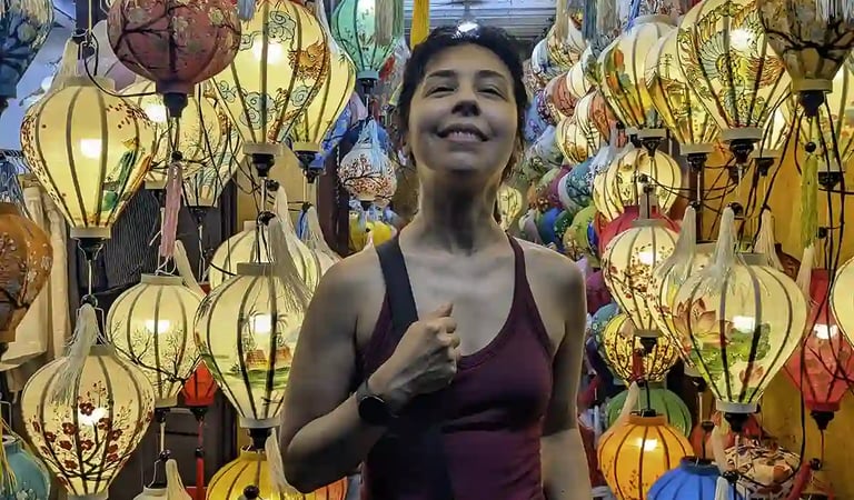 Standing among colorful lanterns in Hoi An, Vietnam