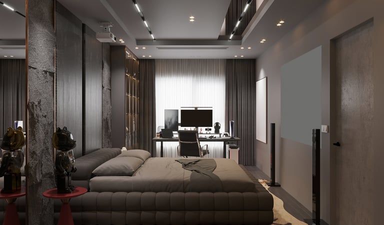 Modern luxury bedroom interior with a tufted gray bed, workstation desk, and home cinema projector.