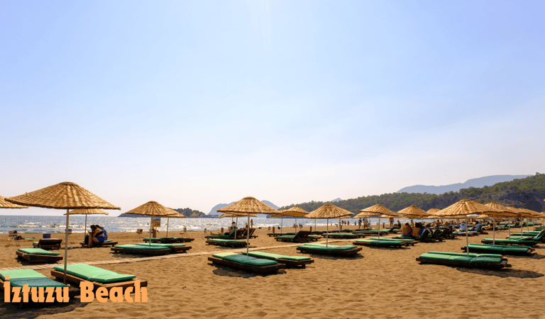 a beach with umbrellas on the sand
