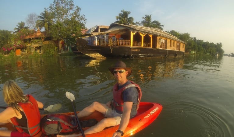 Nick and Tracey Billington canoeing on the waterway at Alappuzha, Kerala, India
