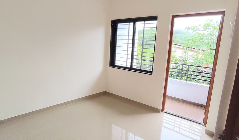 Cozy bedroom at Lakefield Apartments with natural light and hill view at Igatpuri