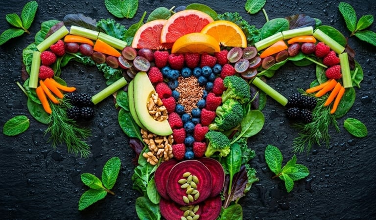 Fresh fruits and vegetables arranged in the shape of a female reproductive system for reproductive health.