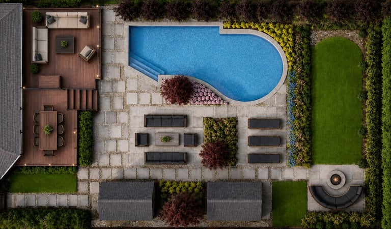 Aerial view of a luxury Toronto backyard landscape design with swimming pool, wood deck, stone patio, and fire pit