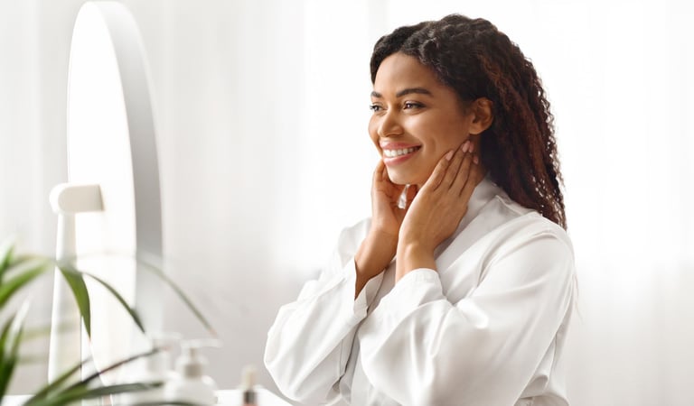 a woman in a white robe is smiling and holding her hands up to her chin